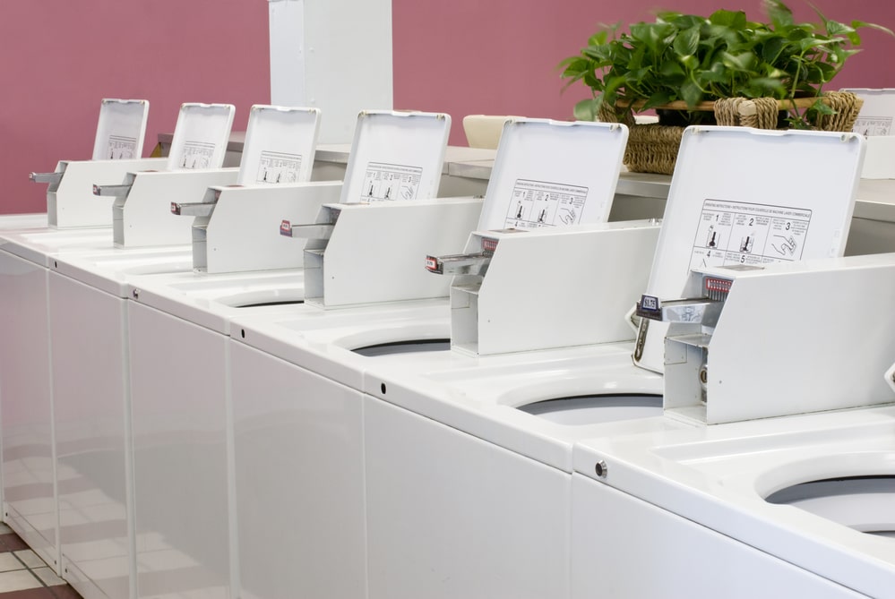 Row of open washers in laundromat