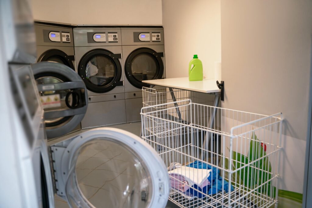 Laundromat with open washers, cart, detergent