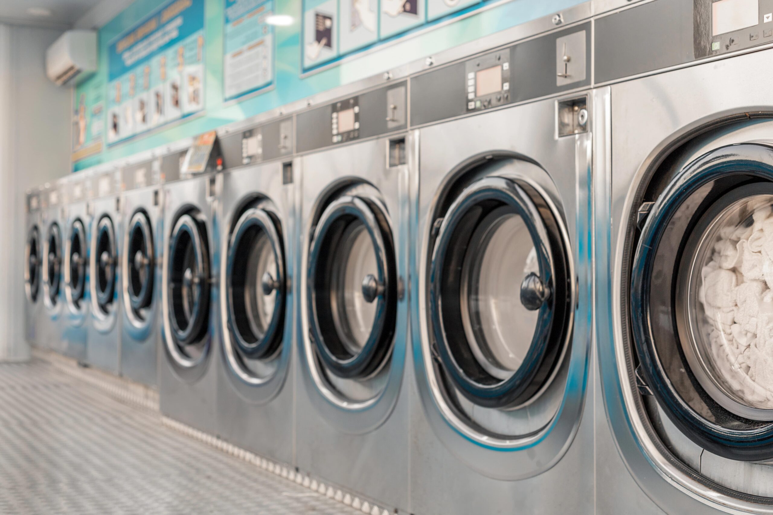 Row of washers in commercial laundromat