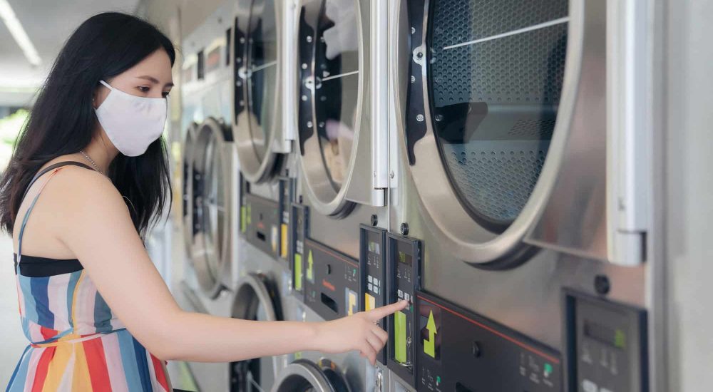 Woman-operating-Laundry-Machine